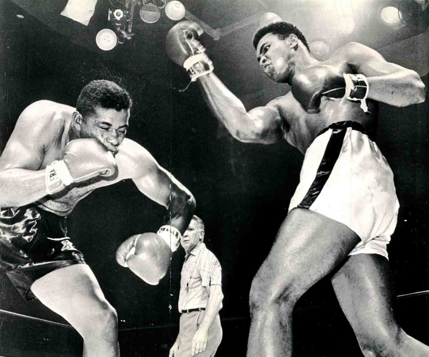 Muhammad Ali landing a powerful right hook on his opponent during a boxing match. (Image Credit/ Photo by Associated Press, via Wikimedia Commons)