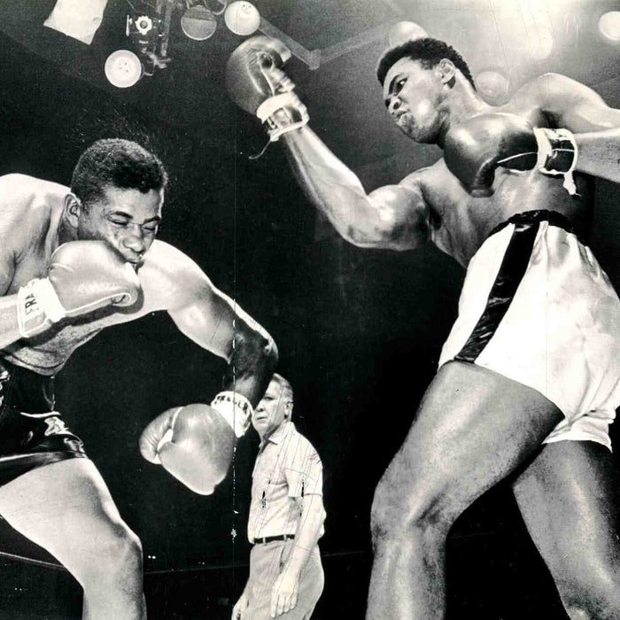 Muhammad Ali landing a powerful right hook on his opponent during a boxing match. (Image Credit/ Photo by Associated Press, via Wikimedia Commons)