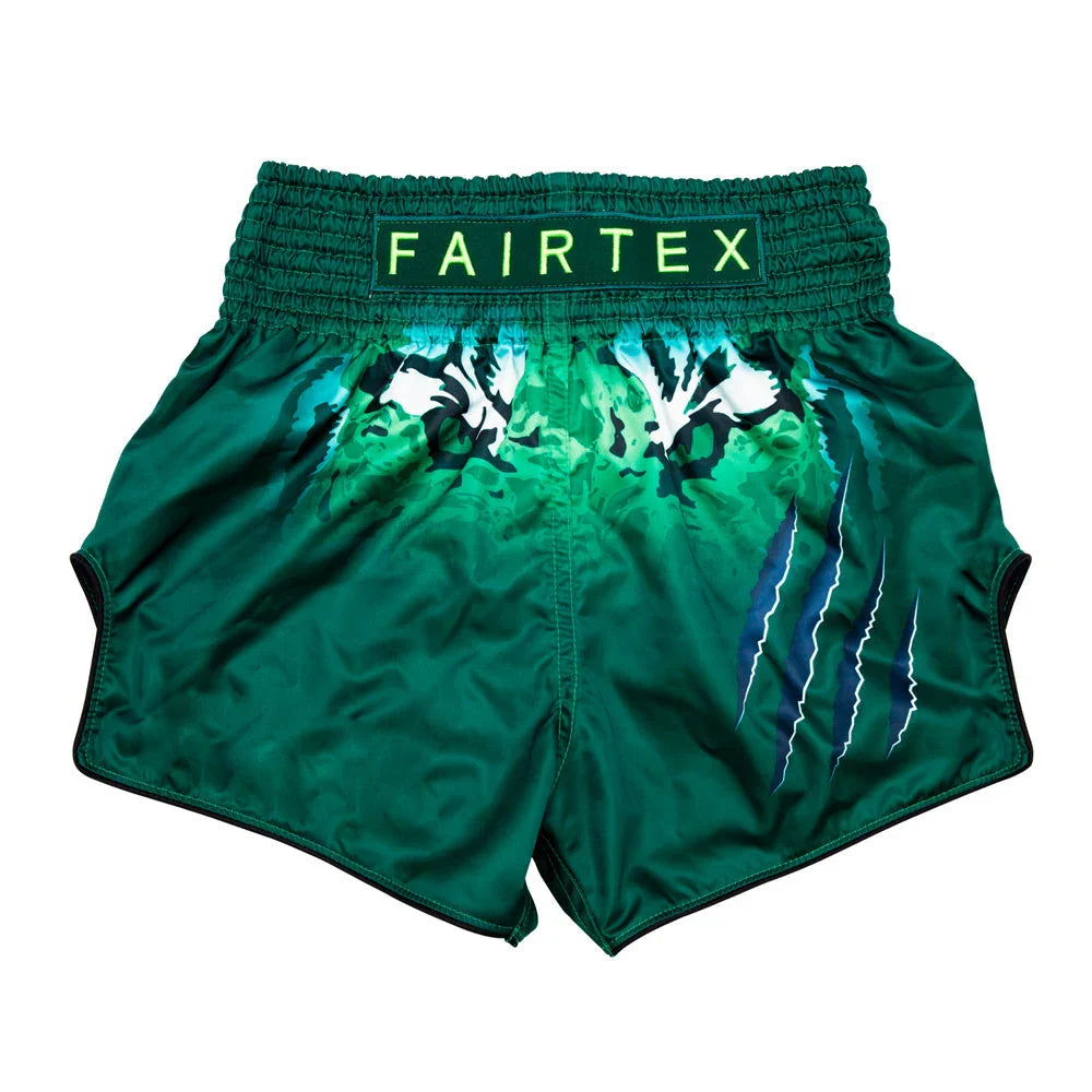 Green Fairtex boxing shorts with a white design on a white background