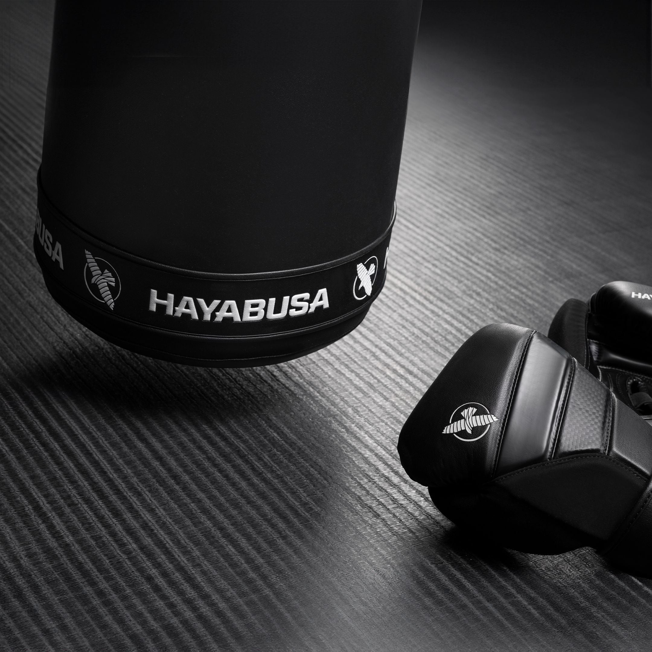 Black boxing glove with Hayabusa branding on a dark textured surface