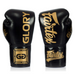 A pair of black Fairtel Glory boxing gloves with gold lettering, displayed side-by-side on a white background.