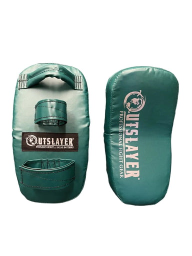 Two teal green martial arts kicking pads with white and black branding, displayed side-by-side on a dark brown surface.