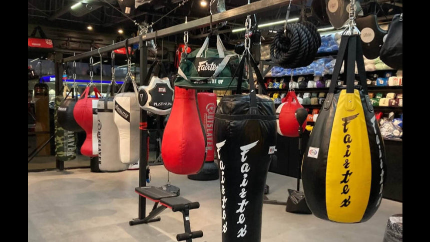 Punching bags hanging from chains in Fighters Shop Outlet