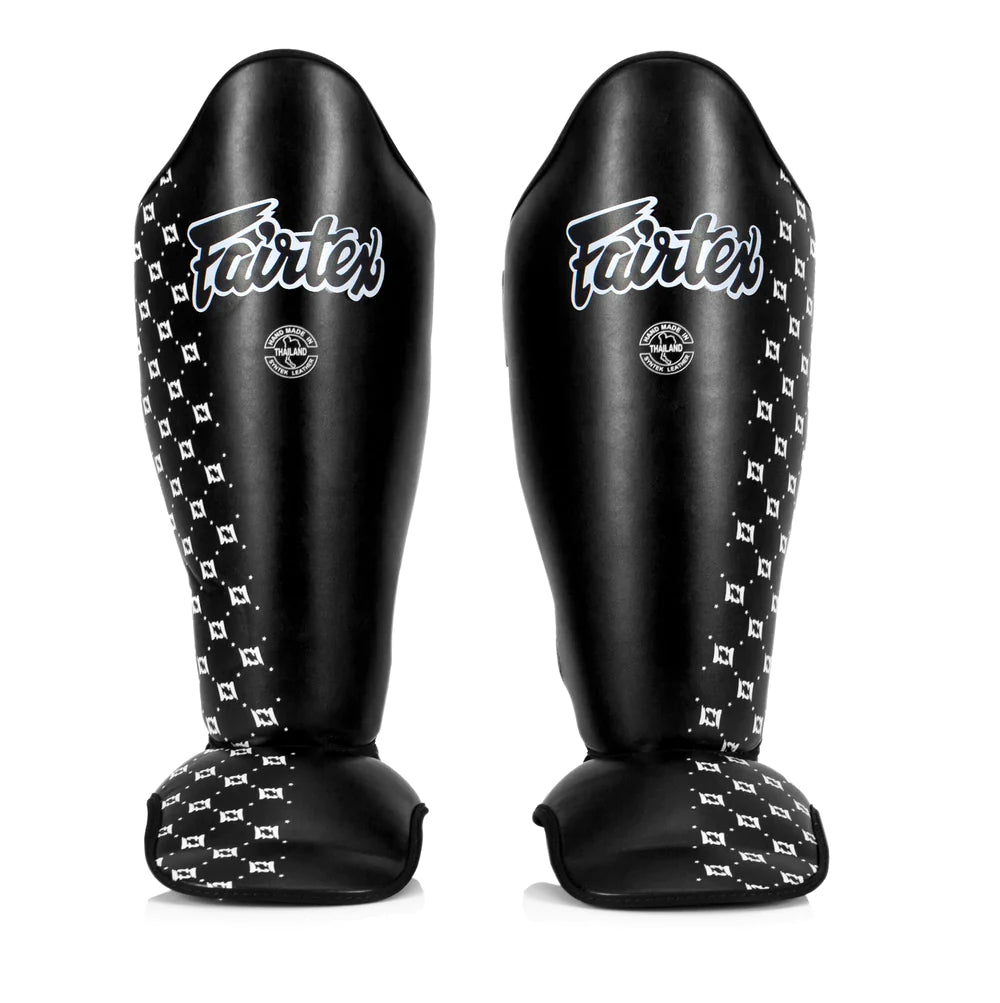 Black Fairtex shin guards with white patterned side panels
