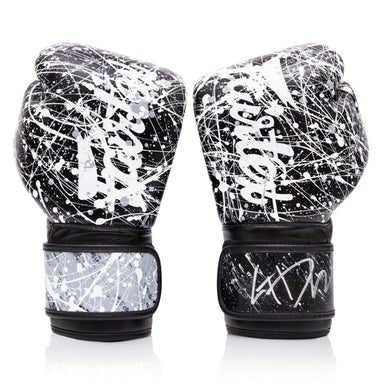 Pair of black and white splatter-patterned boxing gloves on a white background