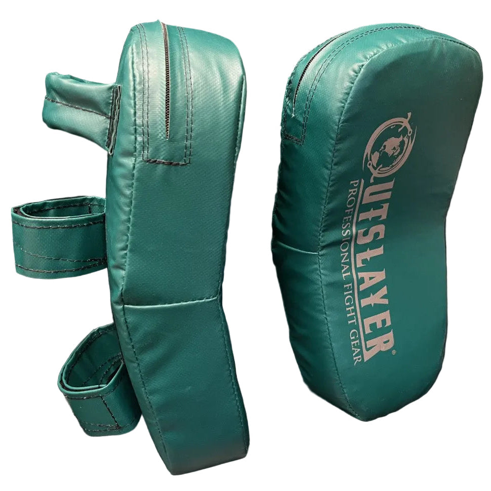 A pair of teal green UFC Slayer boxing and MMA fight gear hand pads shown on a dark, reflective surface. One pad is shown from the side with its straps, and the other is shown from the front displaying the white UFC branding.